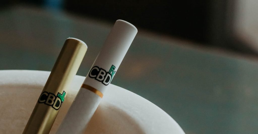 A detailed close-up of CBD vape pens resting in an elegant ashtray.